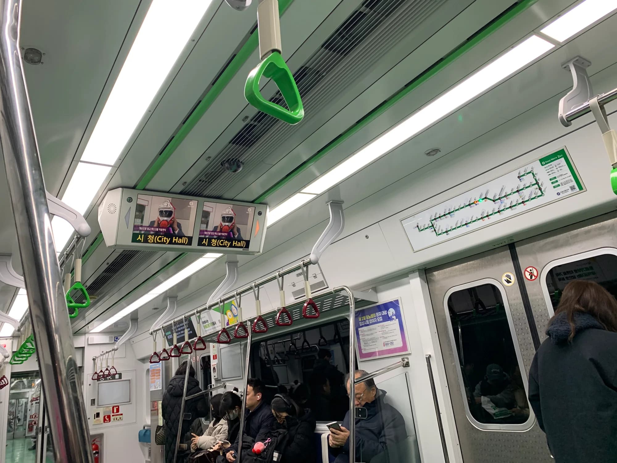 Interior of a Seoul Metro Line 2 train with rows of passenger seats