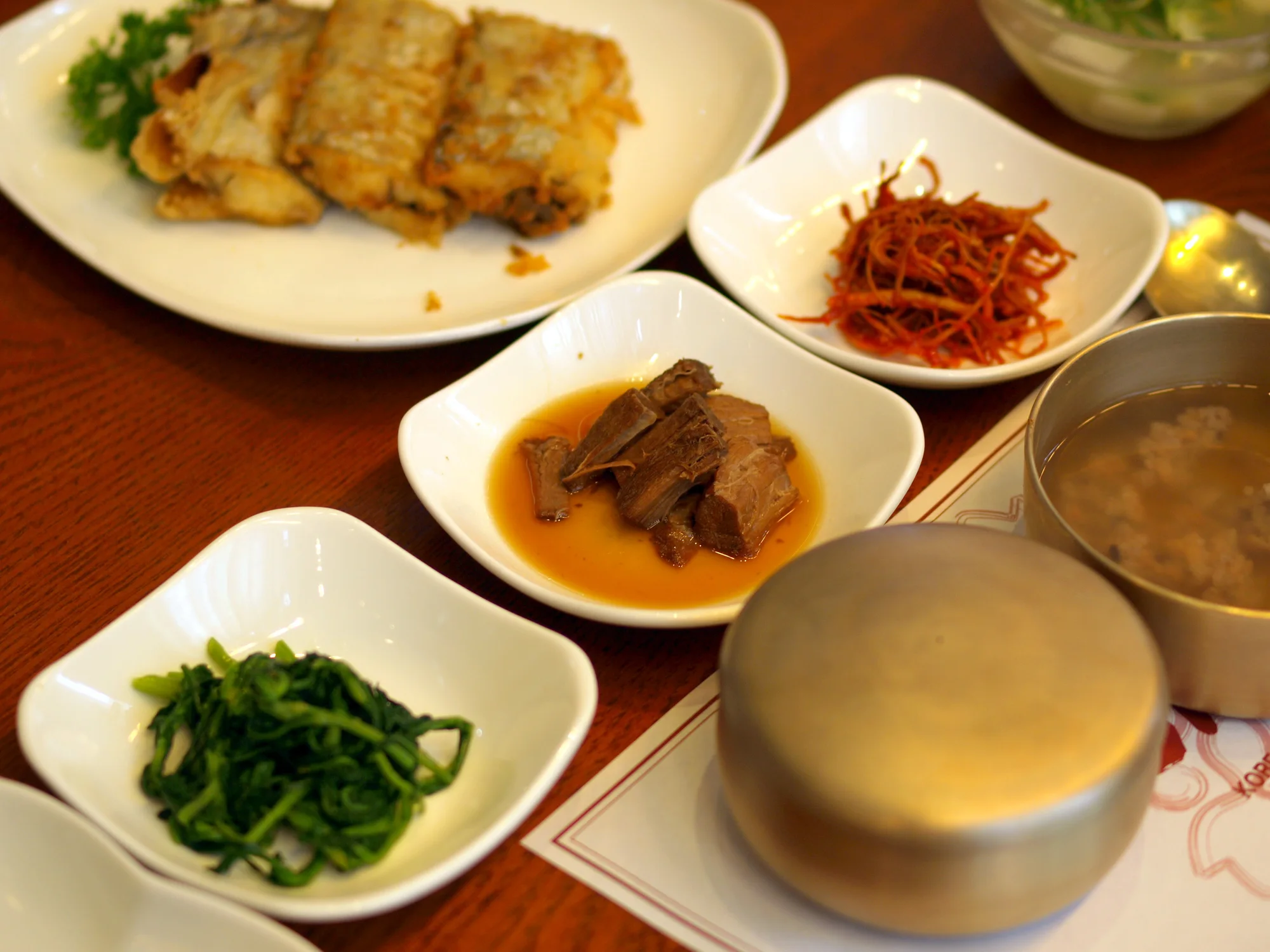 Rice and side dishes arranged on a Korean restaurant table
