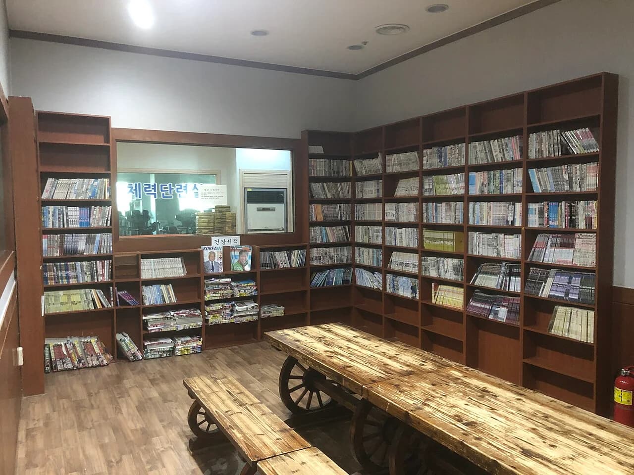 A warm communal relaxation room inside a Korean jjimjilbang