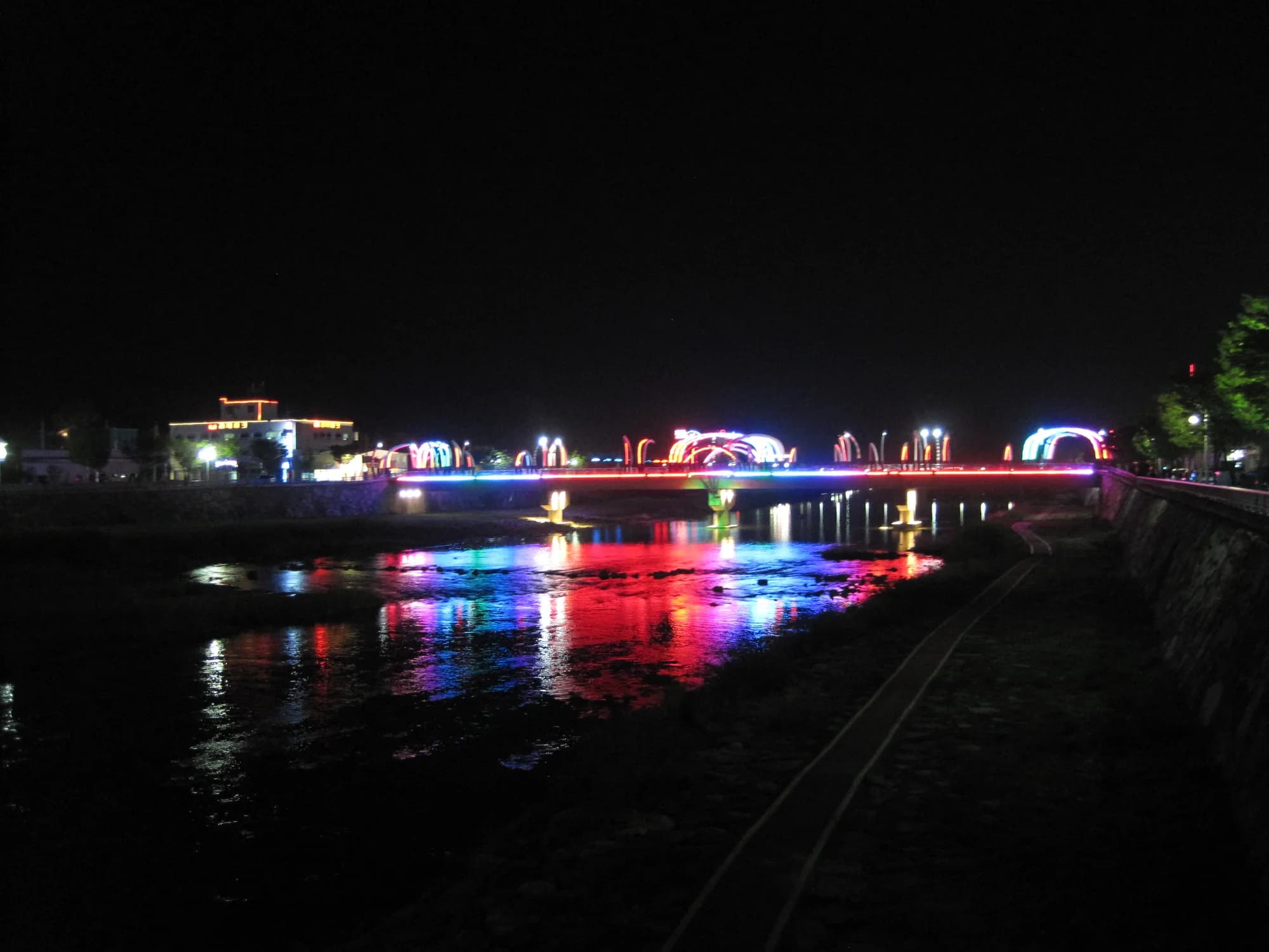 Firefly Bridge illuminated at night in Muju, South Korea