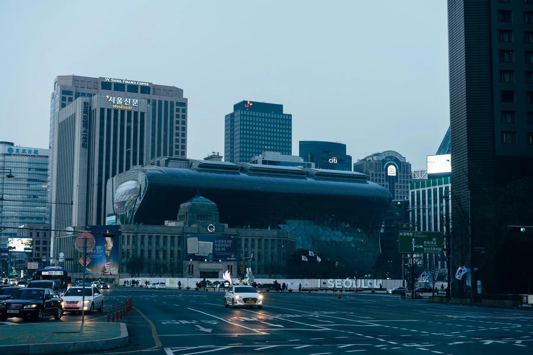 Street-level view of Seoul City Hall and surrounding downtown buildings.
