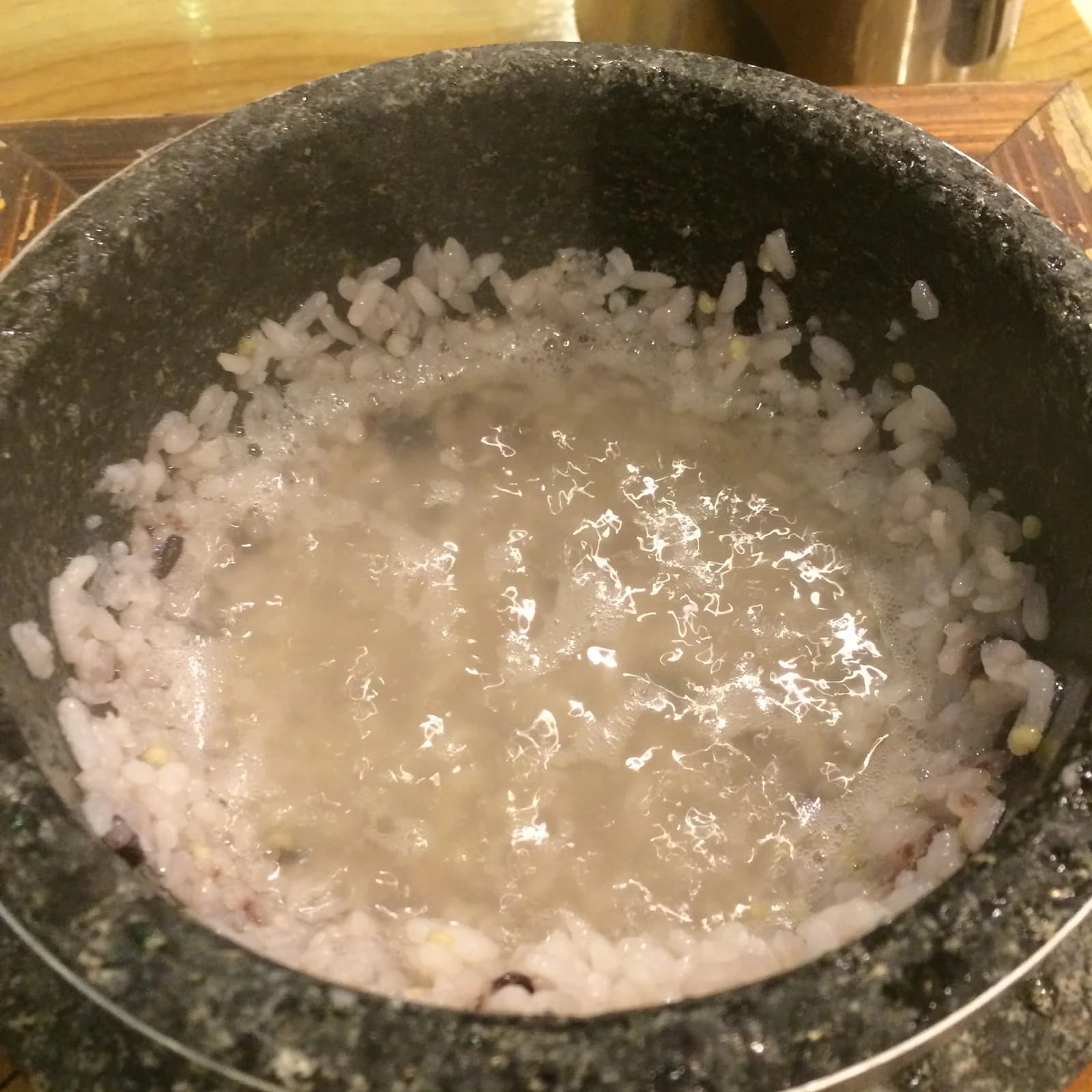 Water and rice remaining in a stone pot during preparation of sungnyung