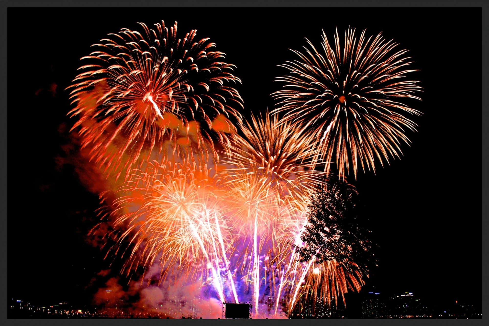 Multiple fireworks bursting above Seoul during the International Fireworks Festival