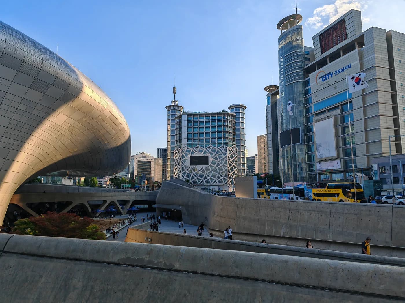 The silver exterior of Dongdaemun Design Plaza beside the surrounding Dongdaemun streets