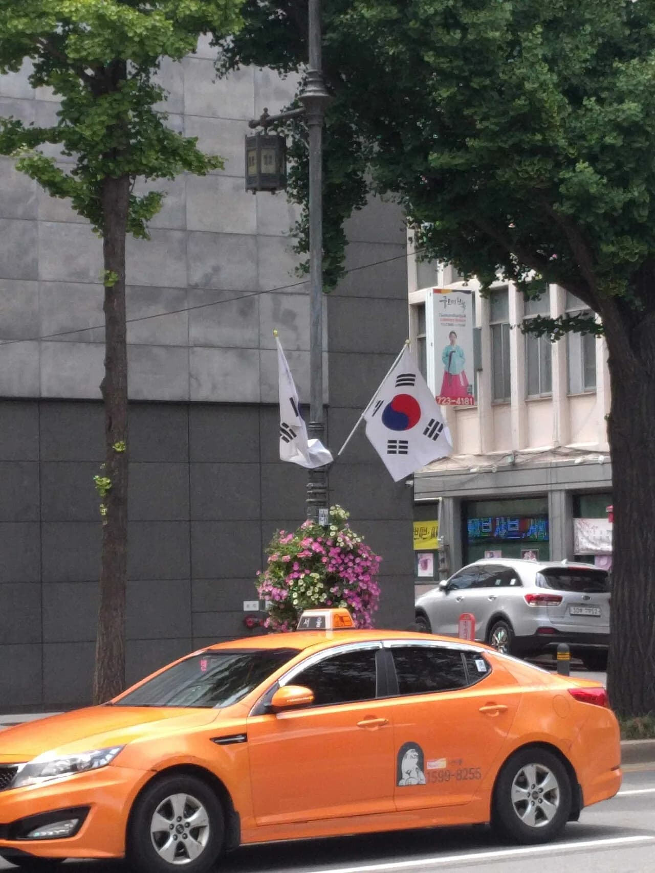 A yellow taxi driving in downtown Seoul