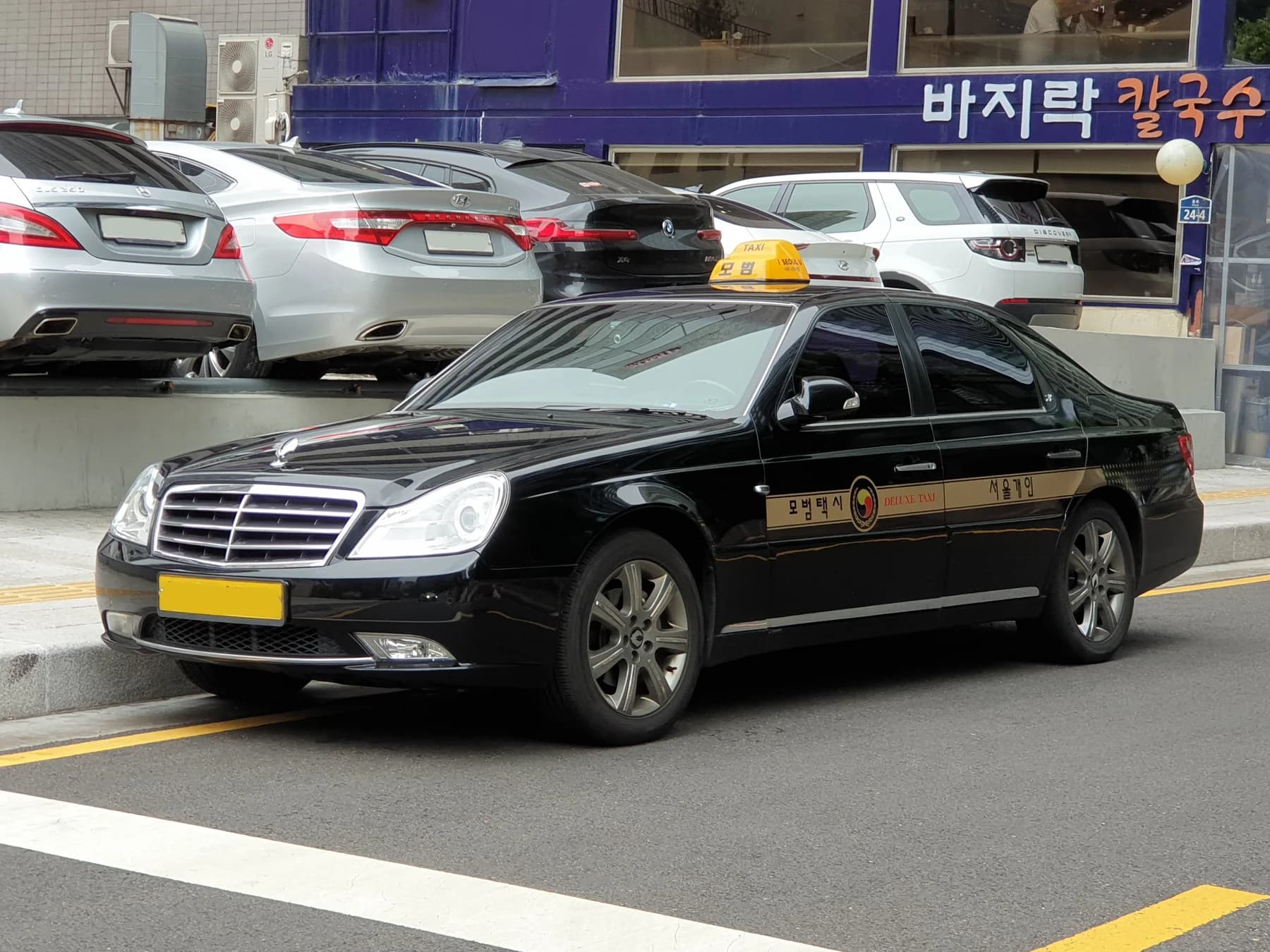 A black deluxe taxi photographed in central Seoul
