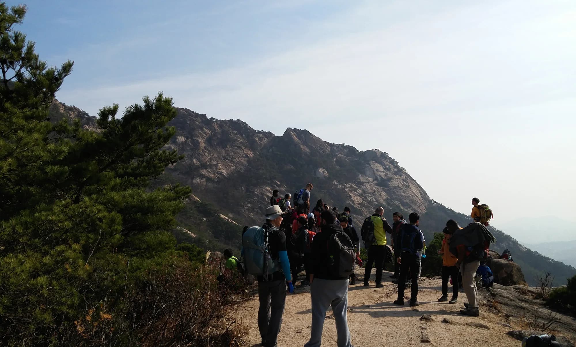 Hikers walking on a rocky trail in Bukhansan National Park
